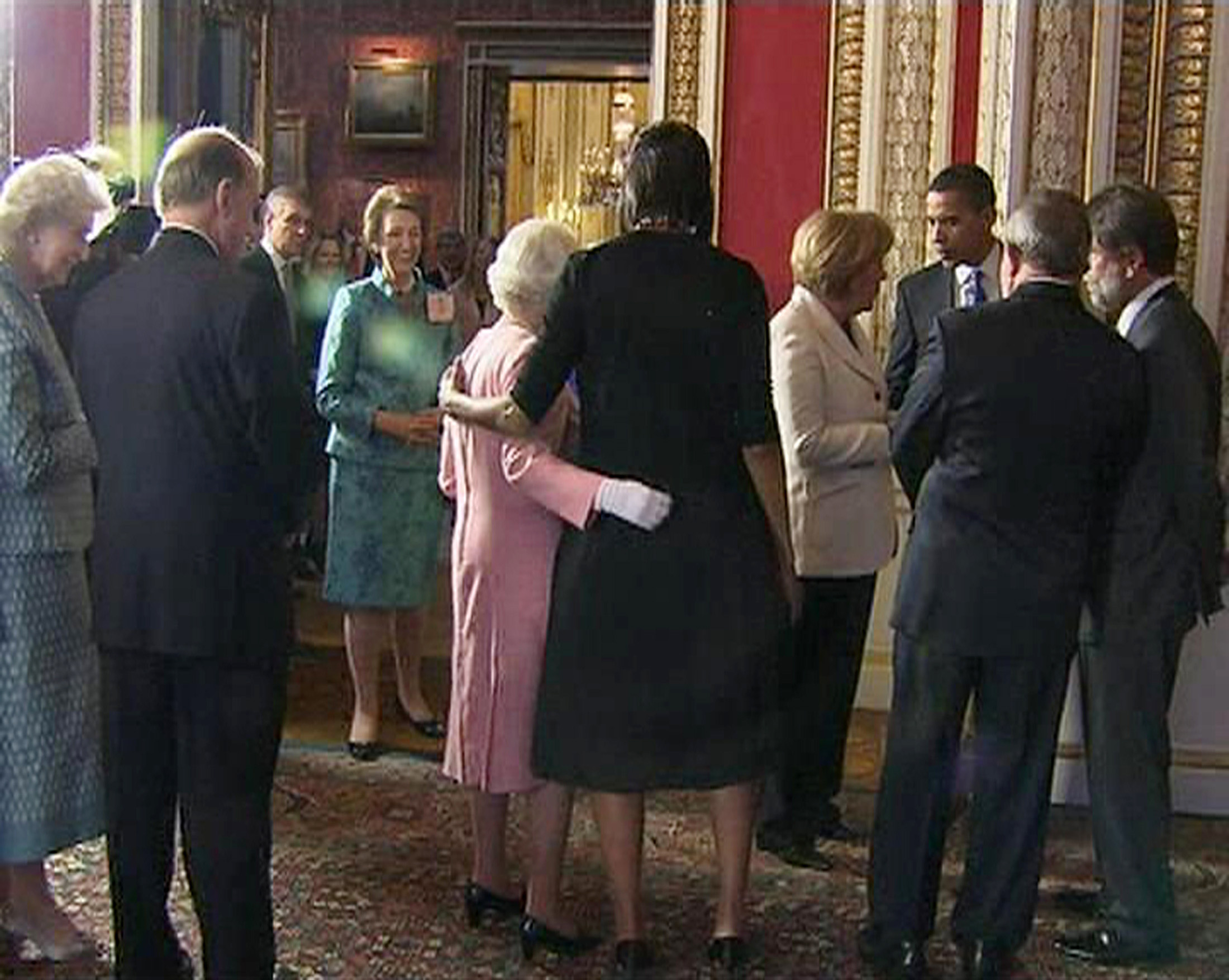 A video grab from television footage shows U.S. first lady Michelle Obama standing with Britain's Queen Elizabeth during a reception for G20 leaders at Buckingham Palace in London, April 1, 2009.