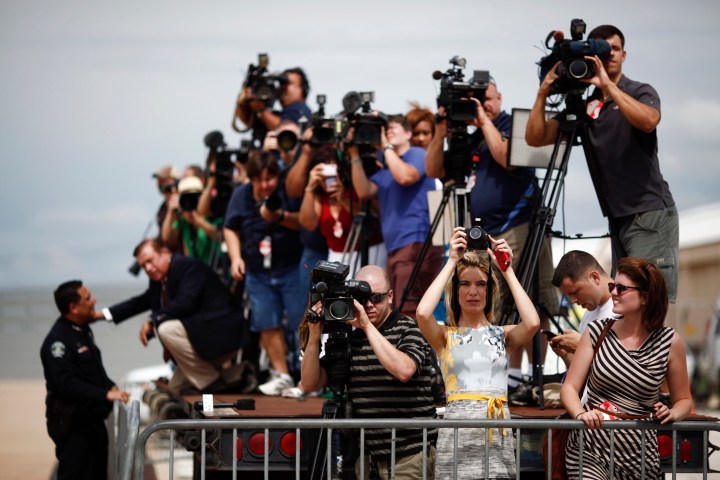 Members of the media train their cameras on President Barack Obama 