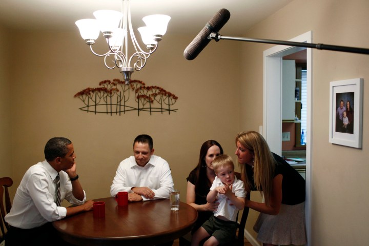 President Barack Obama talks with members of the McLaughlin family during a visit to their home in Cedar Rapids, Iowa.