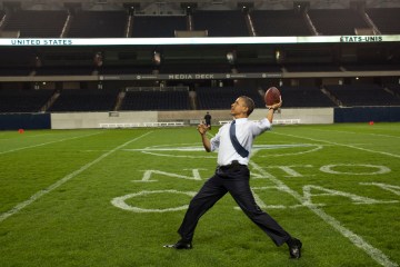 image: President Barack Obama throws a football on the field at Soldier Field following the NATO working dinner in Chicago, May 20, 2012.