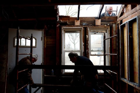 image: Peter Gill, center, works with his father James, left, and friend Mark Faljean on making repairs to his home that was damaged by flood waters during Hurricane Sandy in the New Dorp neighborhood of Staten Island, New York, Jan. 15, 2013.