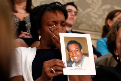 A relative holds up a picture of a gun violence victim during U.S. President Obama's discussion of gun control legislation while delivering his State of the Union Speech on Capitol Hill in Washington