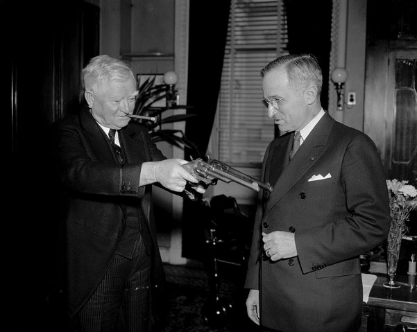 Former President Truman shows off a pair of pistols once owned by Jesse James to Vice President John Nance Garner on Feb. 17, 1938.
