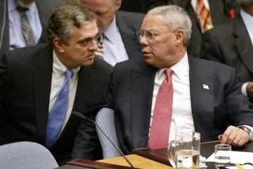 U.S. Secretary of State Colin Powell talks with CIA Director George Tenet after his presentation to the U.N. Security Council in New York