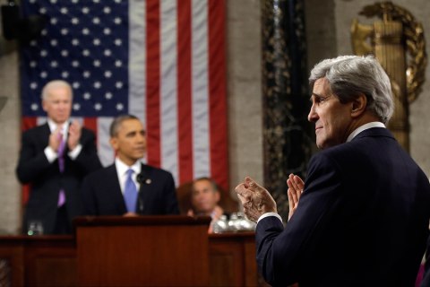 U.S. Secretary of State John Kerry applauds President Barack Obama
