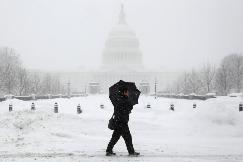 A man walks past the U.S. Capitol during a second major snow storm to affect the Atlantic coast in five days, in Washington