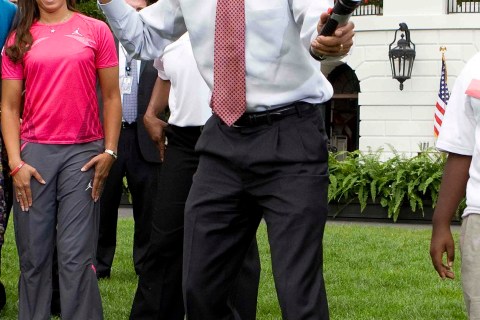 U.S. President Obama uses plastic toy lightsaber to show his fencing stance at the White House in Washington