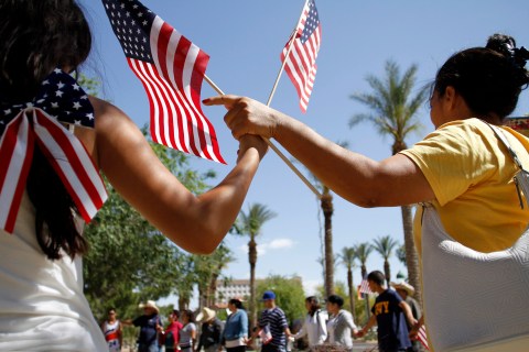 People hold hands and pray as they protest against Senate Bill 1070 outside the Arizona State Capitol in Phoenix