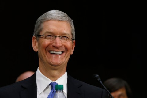 Apple CEO Cook laughs during Senate homeland security and governmental affairs investigations subcommittee hearing in Washington