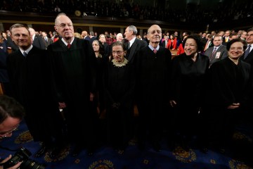 U.S. Supreme Court Justices await the start of President Obama's State of the Union speech on Capitol Hill in Washington
