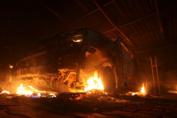 A burning car is seen at the U.S. Consulate in Benghazi during a protest