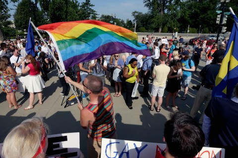 Gay rights supporter Vin Testa waves a rainbow flag outside the U.S. Supreme Court building on June 26, 2013 in Washington, D.C.