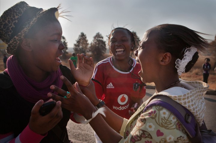 People react to seeing United States President Barack Obama waving from his car window in Soweto Johannesburg. President Obama visited the University of Johannesburg in Soweto for a 'town hall meeting' with students. 