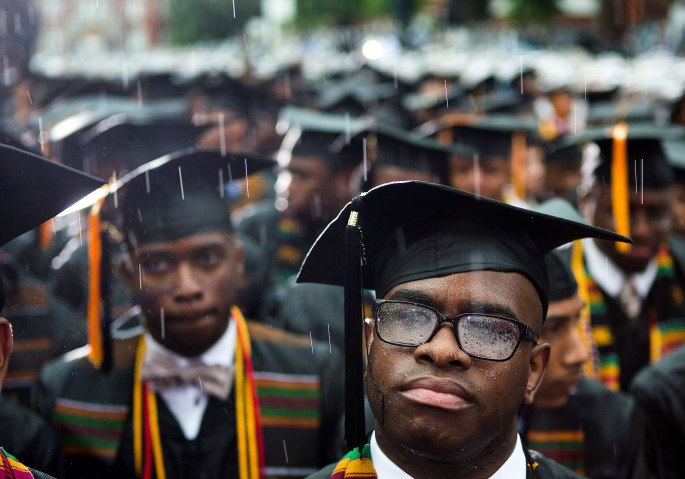 Graduates listen to President Barack Obama deliver a commencement speech as it rains at Morehouse College in Atlanta.