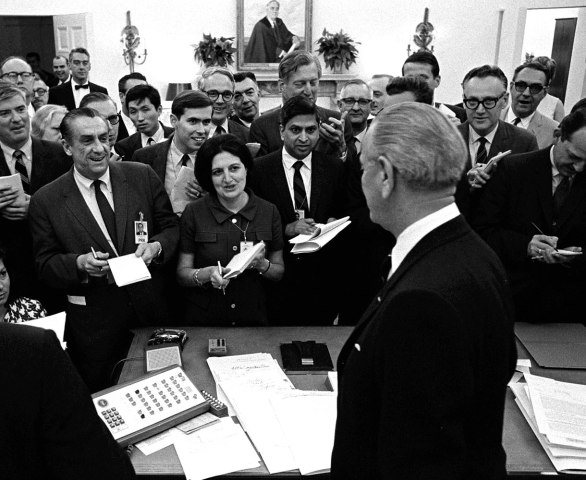White House correspondent Helen Thomas, second left, takes notes as President Lyndon B. Johnson faces reporters during a news conference in the White House Oval Office, April 25, 1968. 