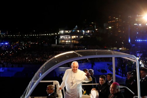 Pope Francis greets Catholic faithful during his arrival at Copacabana beach in Rio de Janeiro