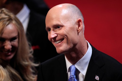 Florida Governor Scott greets an attendee in the audience before the start of the final U.S. presidential debate in Boca Raton