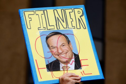 A demonstrator holds up a sign to protest against San Diego Mayor Filner  in downtown San Diego