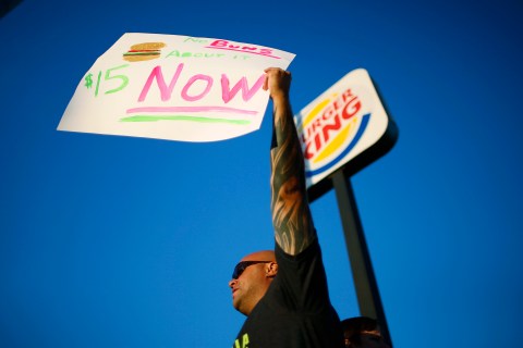 Marcos Oleynick, 36, protests outside Burger King as part of a nationwide strike by fast-food workers to call for wages of $15 an hour, in Los Angeles, California