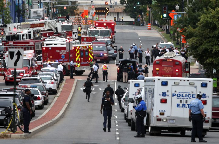 Emergency vehicles and law enforcement personnel respond to a reported shooting at an entrance to the Washington Navy Yard in Washington, D.C., on Sept. 16, 2013.