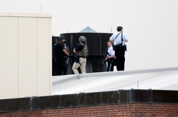 Law enforcement officers are deployed on a rooftop as they respond to a shooting on the base at the Navy Yard in Washington, D.C., on Sept. 16, 2013.