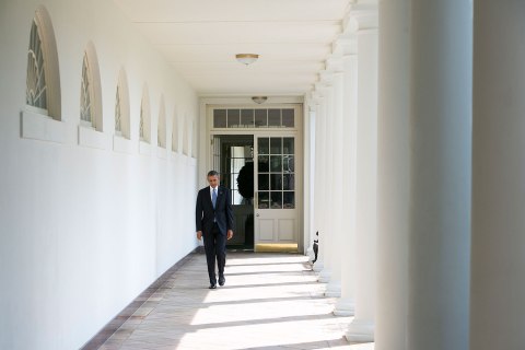 President Barack Obama walks along the colonnade of the White House from the residence to the Oval Office to start his day on September 10, 2013 in Washington.