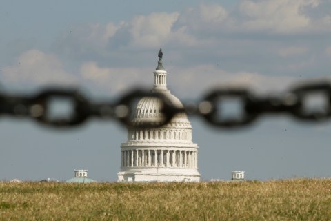 The U.S. Capitol is photographed through a chain fence in Washington