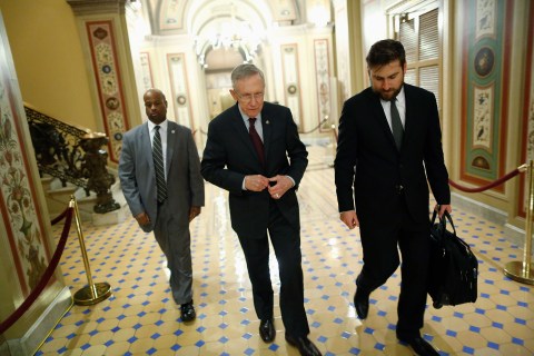 U.S. Senate Majority Leader Reid departs with an aide and his security detail after talks with Republican-controlled U.S. House of Representatives reached a final impasse during a late-night session at the U.S. Capitol