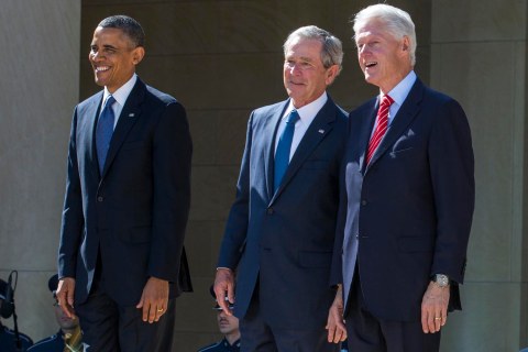 President Barack Obama stands with former presidents George W. Bush, Bill Clinton