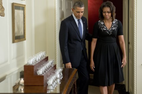 President Barack Obama and First Lady Michelle Obama arrive to light 26 candles honoring the 26 students and teachers killed at Sandy Hook Elementary School in Newtown, Conn., at the White House in Washington, December 14, 2013.
