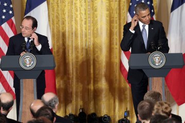 President Barack Obama and French President Francois Hollande arrive for a joint press conference in the East Room at the White House on Feb. 11, 2014 in Washington.